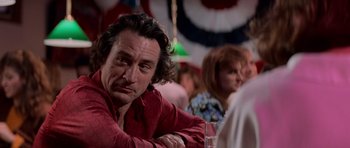 Movie still from “Cape Fear” (1991), directed by Martin Scorsese – A person sitting at a table in a room; Close Up shot, Over the shoulder angle