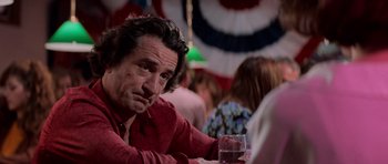 Movie still from “Cape Fear” (1991), directed by Martin Scorsese – A person sitting at a table with a drink; Close Up shot, Over the shoulder angle