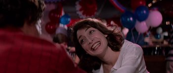 Movie still from “Cape Fear” (1991), directed by Martin Scorsese – A person smiling at a party; Close Up shot, Low angle