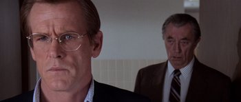 Movie still from “Cape Fear” (1991), directed by Martin Scorsese – A man in a suit standing next to another man in a suit; Close Up shot, Over the shoulder angle