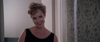 Movie still from “Cape Fear” (1991), directed by Martin Scorsese – A woman with short blonde hair smiling for the camera; Close Up shot, Over the shoulder angle