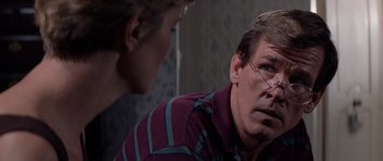 Movie still from “Cape Fear” (1991), directed by Martin Scorsese – A man and a woman are talking to each other in a room; Close Up shot, Over the shoulder angle