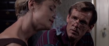 Movie still from “Cape Fear” (1991), directed by Martin Scorsese – A man smoking a cigarette next to another man; Close Up shot, Over the shoulder angle