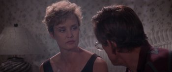 Movie still from “Cape Fear” (1991), directed by Martin Scorsese – A woman looking at her reflection in a mirror; Close Up shot, Over the shoulder angle