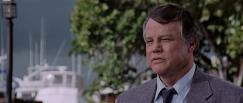 Movie still from “Cape Fear” (1991), directed by Martin Scorsese – An older man in a suit and tie looking sad; Close Up shot, Low angle