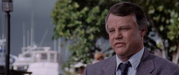 Movie still from “Cape Fear” (1991), directed by Martin Scorsese – An older man in a suit and tie looking sad; Close Up shot, Low angle