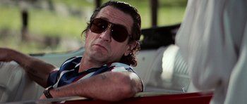 Movie still from “Cape Fear” (1991), directed by Martin Scorsese – A person in a car wearing sunglasses; Close Up shot, Low angle