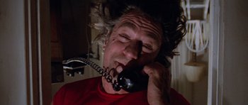 Movie still from “Cape Fear” (1991), directed by Martin Scorsese – An older man talking on a phone while sitting in a chair; Close Up shot, Low angle