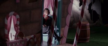 Movie still from “Cape Fear” (1991), directed by Martin Scorsese – A man sitting on a chair in front of a mirror; Medium shot, Low angle