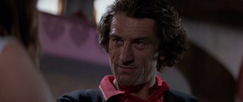 Movie still from “Cape Fear” (1991), directed by Martin Scorsese – A person wearing a red and black shirt; Close Up shot, Low angle