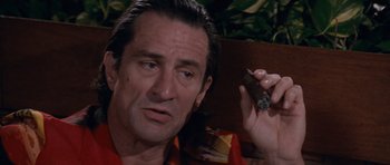Movie still from “Cape Fear” (1991), directed by Martin Scorsese – A person holding a cigar; Close Up shot, Low angle