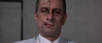 Movie still from “Cape Fear” (1991), directed by Martin Scorsese – A person wearing a suit and tie; Close Up shot, Low angle