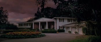 Movie still from “Cape Fear” (1991), directed by Martin Scorsese – A large white house sitting next to a tree; Extreme Wide shot, Low angle