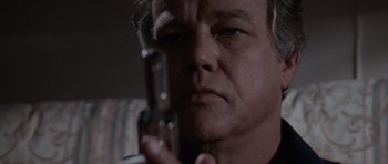 Movie still from “Cape Fear” (1991), directed by Martin Scorsese – A person holding a gun; Close Up shot, Low angle