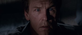 Movie still from “Cape Fear” (1991), directed by Martin Scorsese – A person's face in a dark room; Close Up shot, Low angle
