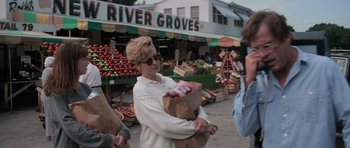 Movie still from “Cape Fear” (1991), directed by Martin Scorsese – A woman carrying a bag of fruit in a market; Medium shot, Over the shoulder angle