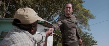 Movie still from “Cape Fear” (1991), directed by Martin Scorsese – A man holding a man's hand while standing next to another man; Medium shot, Over the shoulder angle