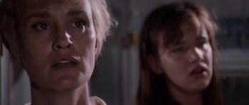 Movie still from “Cape Fear” (1991), directed by Martin Scorsese – A woman looking at the camera while another woman looks at the camera; Close Up shot, Over the shoulder angle