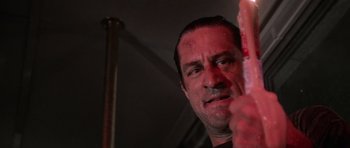 Movie still from “Cape Fear” (1991), directed by Martin Scorsese – A person holding something in his hand; Close Up shot, Low angle
