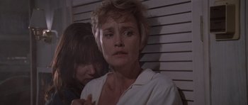 Movie still from “Cape Fear” (1991), directed by Martin Scorsese – A woman in a white shirt is standing next to another woman; Close Up shot, Low angle