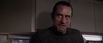 Movie still from “Cape Fear” (1991), directed by Martin Scorsese – A person in a dark room; Close Up shot, Low angle