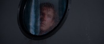 Movie still from “Cape Fear” (1991), directed by Martin Scorsese – A man looking into a bathroom mirror with rain; Close Up shot, Low angle