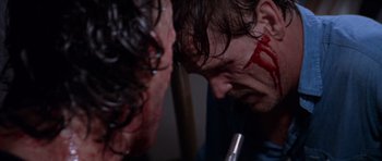 Movie still from “Cape Fear” (1991), directed by Martin Scorsese – A man with blood all over his face and neck; Close Up shot, Over the shoulder angle