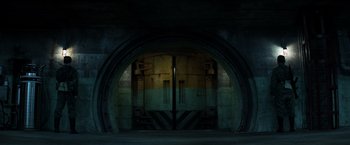 Movie still from “Captain America: Civil War” (2016), directed by Anthony Russo – An open door in a dark room with a light shining on it; Extreme Wide shot, Low angle