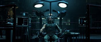 Movie still from “Captain America: Civil War” (2016), directed by Anthony Russo – A man sitting in a chair in front of lights; Medium shot, Low angle