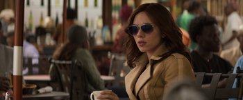Movie still from “Captain America: Civil War” (2016), directed by Anthony Russo – A woman in sunglasses holding a coffee cup; Close Up shot, Over the shoulder angle