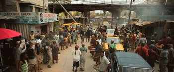 Movie still from “Captain America: Civil War” (2016), directed by Anthony Russo – A group of people walking down a street next to cars; Extreme Wide shot, High angle