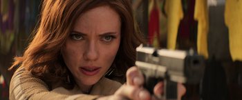 Movie still from “Captain America: Civil War” (2016), directed by Anthony Russo – A person holding a gun; Close Up shot, Over the shoulder angle