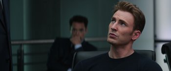 Movie still from “Captain America: Civil War” (2016), directed by Anthony Russo – A man sitting next to another man in front of a window; Close Up shot, Over the shoulder angle
