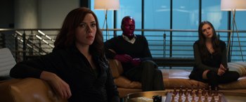 Movie still from “Captain America: Civil War” (2016), directed by Anthony Russo – A woman sitting on a couch next to a man; Medium shot, Over the shoulder angle