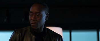 Movie still from “Captain America: Civil War” (2016), directed by Anthony Russo – A man in a leather jacket is looking down; Close Up shot, Over the shoulder angle