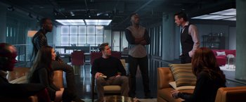 Movie still from “Captain America: Civil War” (2016), directed by Anthony Russo – Two men are sitting in a living room watching tv; Wide shot, High angle