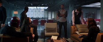 Movie still from “Captain America: Civil War” (2016), directed by Anthony Russo – A group of people sitting around a room; Wide shot, Over the shoulder angle