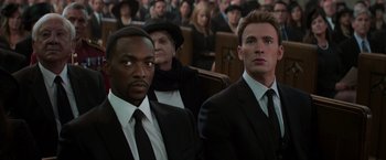 Movie still from “Captain America: Civil War” (2016), directed by Anthony Russo – Two men in suits and ties sitting next to each other; Close Up shot, Low angle
