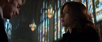 Movie still from “Captain America: Civil War” (2016), directed by Anthony Russo – A woman standing in front of a stained glass window; Close Up shot, Low angle