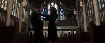 Movie still from “Captain America: Civil War” (2016), directed by Anthony Russo – A man and a woman standing in front of a stained glass window; Medium shot, Low angle