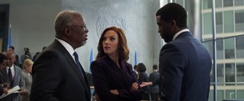Movie still from “Captain America: Civil War” (2016), directed by Anthony Russo – A woman in a purple suit standing next to two other men; Medium shot, Low angle