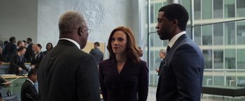 Movie still from “Captain America: Civil War” (2016), directed by Anthony Russo – Two men and a woman standing in front of a building; Medium shot, Over the shoulder angle