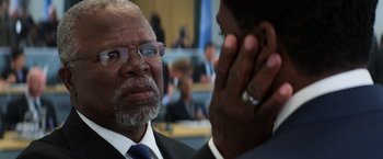 Movie still from “Captain America: Civil War” (2016), directed by Anthony Russo – A man in a suit and tie talking to another man in a suit and tie; Close Up shot, Over the shoulder angle