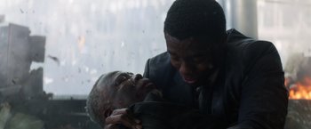 Movie still from “Captain America: Civil War” (2016), directed by Anthony Russo – Two men in suits are wrestling in the rain; Close Up shot, Over the shoulder angle