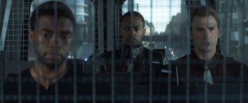 Movie still from “Captain America: Civil War” (2016), directed by Anthony Russo – A man sitting in front of a cage; Close Up shot, Over the shoulder angle
