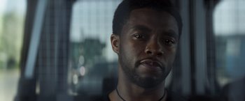 Movie still from “Captain America: Civil War” (2016), directed by Anthony Russo – A man's face in front of a window; Close Up shot, Low angle