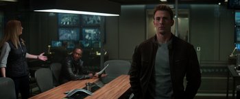 Movie still from “Captain America: Civil War” (2016), directed by Anthony Russo – Two men are sitting at a table in a room; Medium shot, Over the shoulder angle
