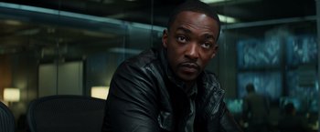 Movie still from “Captain America: Civil War” (2016), directed by Anthony Russo – A man in a leather jacket is looking at the camera; Close Up shot, Over the shoulder angle