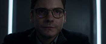 Movie still from “Captain America: Civil War” (2016), directed by Anthony Russo – A person wearing glasses; Close Up shot, Over the shoulder angle