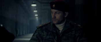 Movie still from “Captain America: Civil War” (2016), directed by Anthony Russo – A man in a military uniform looking to his left; Close Up shot, Low angle